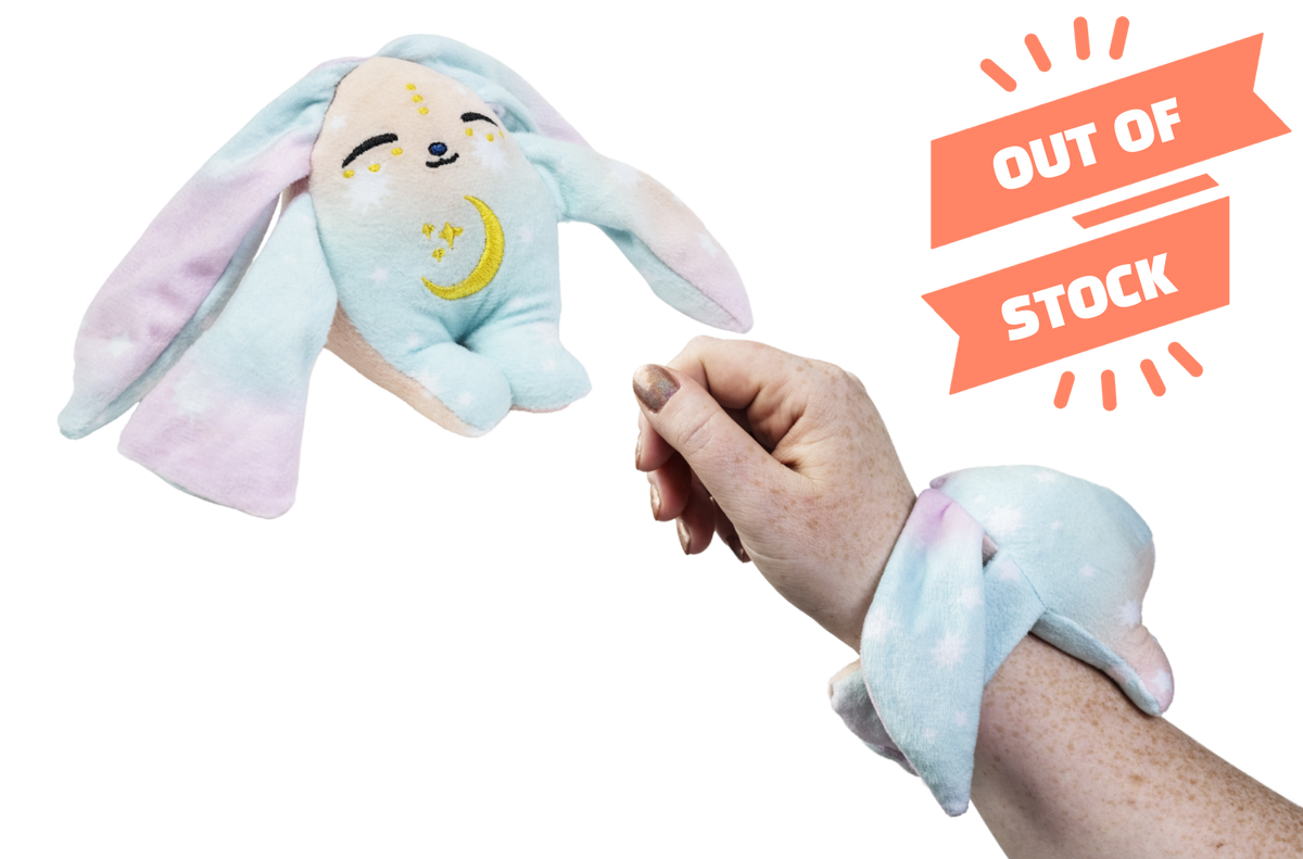Aura Mini Wrist Hugger, a small pink Moon Pals wrist plush